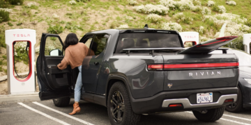 Rivian R1T charging at a Tesla Supercharger station